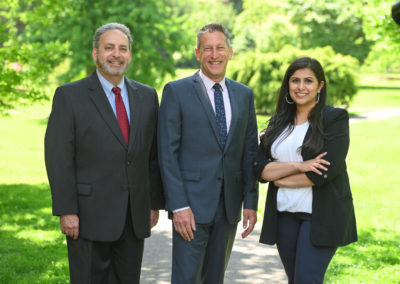 Andrew Zwicker, Roy Freiman, and Sadaf Jaffer pose for a team photo in the park.