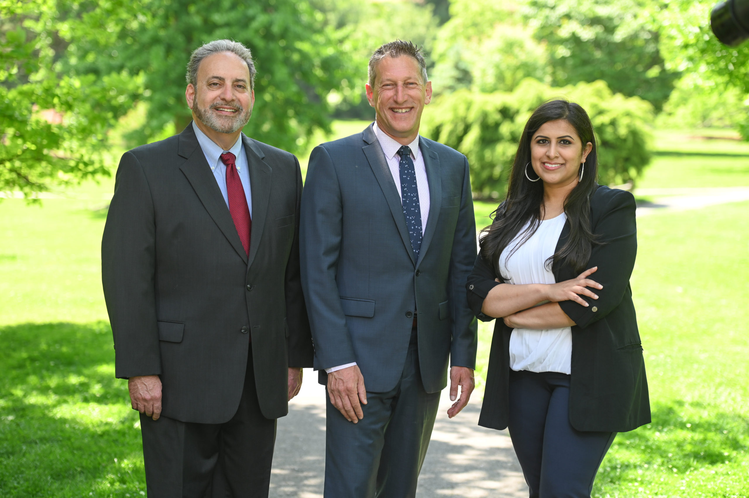Andrew Zwicker, Roy Freiman, and Sadaf Jaffer pose for a team photo in the park.