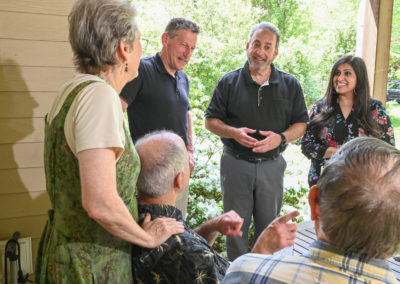 Andrew Zwicker, Roy Freiman, and Sadaf Jaffer talk with locals during a local canvasing event.